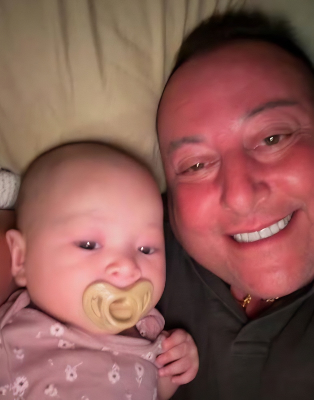 David sits up with his baby - Instagram